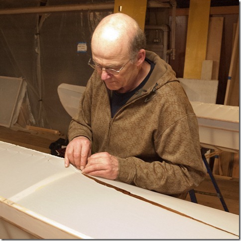Dave is sewing the bow of his boat Dave is sewing the bow of his boat